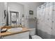 Bathroom with a sink, toilet, shower with curtain, and view into an adjacent room at 4712 Charles Partin Dr, Parrish, FL 34219