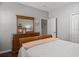 Cozy bedroom with a dresser and mirror, neutral walls, and a plush comforter at 4712 Charles Partin Dr, Parrish, FL 34219