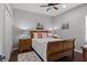 Charming bedroom featuring a wooden bed frame, ceiling fan, and neutral colored walls at 4712 Charles Partin Dr, Parrish, FL 34219