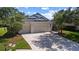 Attractive single-story home featuring a three-car garage, a well-maintained lawn, and a pleasant curb appeal at 4712 Charles Partin Dr, Parrish, FL 34219