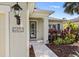 Inviting front entrance featuring a decorative address plaque, a glass-paneled door, and lush landscaping at 4712 Charles Partin Dr, Parrish, FL 34219