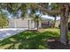 Charming single-story home with a well-manicured lawn and a three-car garage, enhanced by mature trees and landscaping at 4712 Charles Partin Dr, Parrish, FL 34219