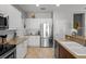 Modern kitchen with stainless steel appliances, granite countertops and white cabinets at 4712 Charles Partin Dr, Parrish, FL 34219