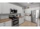 Modern kitchen with white cabinets, stainless steel appliances and sleek countertops at 4712 Charles Partin Dr, Parrish, FL 34219
