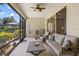 Bright and airy lanai with comfortable seating, ceiling fan, and screened windows that provide panoramic views of the backyard at 4712 Charles Partin Dr, Parrish, FL 34219