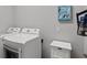 Laundry room with a washer and dryer, storage, and decor at 4712 Charles Partin Dr, Parrish, FL 34219