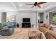 Cozy living room with tile floors, neutral paint, ceiling fan and comfortable seating at 4712 Charles Partin Dr, Parrish, FL 34219