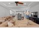 Open concept living room with tile floors, neutral paint, and ceiling fan at 4712 Charles Partin Dr, Parrish, FL 34219
