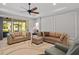 Large living room with tan couches, large rug, ceiling fan, and decorative trim at 4712 Charles Partin Dr, Parrish, FL 34219