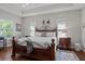 Spacious main bedroom with hardwood floors, a tray ceiling, and plenty of natural light at 4712 Charles Partin Dr, Parrish, FL 34219