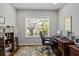 Office with a large window, desk, and hardwood floors at 4712 Charles Partin Dr, Parrish, FL 34219