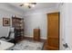 Office with hardwood floors, a wooden armoire and bookcase, and a ceiling fan at 4712 Charles Partin Dr, Parrish, FL 34219