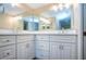 Bathroom featuring dual vanity with mirrors and storage underneath at 4812 Kestral Park Cir # 20, Sarasota, FL 34231