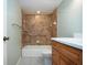 Bathroom featuring a tiled shower with a bathtub and a wooden vanity with marble countertop at 4812 Kestral Park Cir # 20, Sarasota, FL 34231