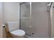 Bathroom featuring a toilet and a shower with tiled walls and a glass door at 4812 Kestral Park Cir # 20, Sarasota, FL 34231