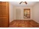 Bedroom with terra-cotta tile flooring, closet, and shuttered window overlooking greenery at 4812 Kestral Park Cir # 20, Sarasota, FL 34231