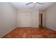 Bedroom featuring terracotta tile flooring, a ceiling fan, and closet with bifold doors at 4812 Kestral Park Cir # 20, Sarasota, FL 34231