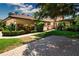 Charming home with lush landscaping, a brick driveway, and a well-maintained lawn at 4812 Kestral Park Cir # 20, Sarasota, FL 34231