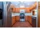 Kitchen with stainless steel appliances, ample wood cabinets, and tile flooring at 4812 Kestral Park Cir # 20, Sarasota, FL 34231