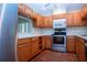 Traditional kitchen featuring stainless steel appliances, wood cabinets, and light countertops at 4812 Kestral Park Cir # 20, Sarasota, FL 34231