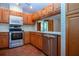 Traditional kitchen featuring stainless steel appliances, wood cabinets, and light countertops at 4812 Kestral Park Cir # 20, Sarasota, FL 34231