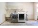 Laundry room featuring a washer, dryer, utility sink, and wire shelving for storage at 4812 Kestral Park Cir # 20, Sarasota, FL 34231