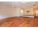 Large living area with Saltillo tile, natural lighting, and an opening to the kitchen at 4812 Kestral Park Cir # 20, Sarasota, FL 34231