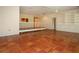 Bright living room area featuring Saltillo tile, opening to the kitchen, and built-in shelving at 4812 Kestral Park Cir # 20, Sarasota, FL 34231