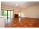 Spacious living room with Saltillo tile, fireplace, and sliding glass doors to the backyard at 4812 Kestral Park Cir # 20, Sarasota, FL 34231
