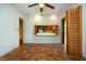 Living room with terra-cotta tile flooring and a shuttered pass-through view of the kitchen at 4812 Kestral Park Cir # 20, Sarasota, FL 34231