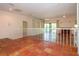 Open floor plan with Saltillo tile, fireplace, shelving, and sliding glass doors at 4812 Kestral Park Cir # 20, Sarasota, FL 34231