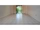 Sunlit living room features tiled floors and sliding doors to the outdoor at 4812 Kestral Park Cir # 20, Sarasota, FL 34231