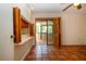 Living room with terra-cotta tile flooring and view of a sunroom through shuttered pass-through at 4812 Kestral Park Cir # 20, Sarasota, FL 34231