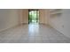 Sunlit living room features tiled floors and sliding doors to the outdoor at 4812 Kestral Park Cir # 20, Sarasota, FL 34231