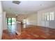 Bright living room with Saltillo tile, fireplace, sliding glass doors, and white wood shutters at 4812 Kestral Park Cir # 20, Sarasota, FL 34231
