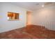 Living room featuring Saltillo tile, opening looking into kitchen, and white stair railing at 4812 Kestral Park Cir # 20, Sarasota, FL 34231