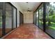 Enclosed patio features tile flooring, ceiling fan, and sliding glass doors to the garden at 4812 Kestral Park Cir # 20, Sarasota, FL 34231