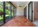 Enclosed patio features tile flooring, ceiling fan, and sliding glass doors to the garden at 4812 Kestral Park Cir # 20, Sarasota, FL 34231