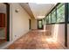 Bright sunroom with terra-cotta flooring, skylights, and sliding glass doors to the exterior at 4812 Kestral Park Cir # 20, Sarasota, FL 34231