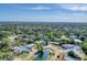 Picturesque aerial view of a neighborhood featuring lush greenery and a scenic pond within the community at 4907 4Th Avenue Nw Cir, Bradenton, FL 34209