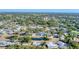 Expansive aerial view of residential homes, green trees and a calm pond nestled within a community at 4907 4Th Avenue Nw Cir, Bradenton, FL 34209