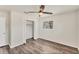 Bright bedroom with hardwood flooring, ceiling fan, closet, and a window allowing for natural light at 4907 4Th Avenue Nw Cir, Bradenton, FL 34209