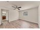 Bedroom featuring sleek flooring, ceiling fan, and window providing natural light at 4907 4Th Avenue Nw Cir, Bradenton, FL 34209