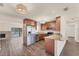 Modern kitchen with stainless steel appliances, granite countertops, and stylish wood cabinets, seamlessly connected to the living space at 4907 4Th Avenue Nw Cir, Bradenton, FL 34209