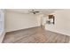 Open-concept living area with wood-look floors, a ceiling fan, and views into the updated kitchen with stainless appliances at 4907 4Th Avenue Nw Cir, Bradenton, FL 34209