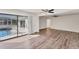 Spacious living area boasts sleek flooring and sliding glass doors to the outdoor pool at 4907 4Th Avenue Nw Cir, Bradenton, FL 34209