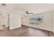 Bright living room with wood-look floors, large windows offering ample natural light, and a modern ceiling fan at 4907 4Th Avenue Nw Cir, Bradenton, FL 34209