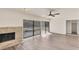 Bright living room with a cozy fireplace, wood-look flooring, and access to the outdoors through large sliding glass doors at 4907 4Th Avenue Nw Cir, Bradenton, FL 34209
