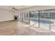 Inviting living room with backyard access via sliding glass doors and a view of the screened-in pool area at 4907 4Th Avenue Nw Cir, Bradenton, FL 34209
