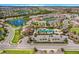 Expansive aerial shot showcases the community's pool, clubhouse, playground, lake, and residential layout at 5237 Blossom Cv, Lakewood Ranch, FL 34211